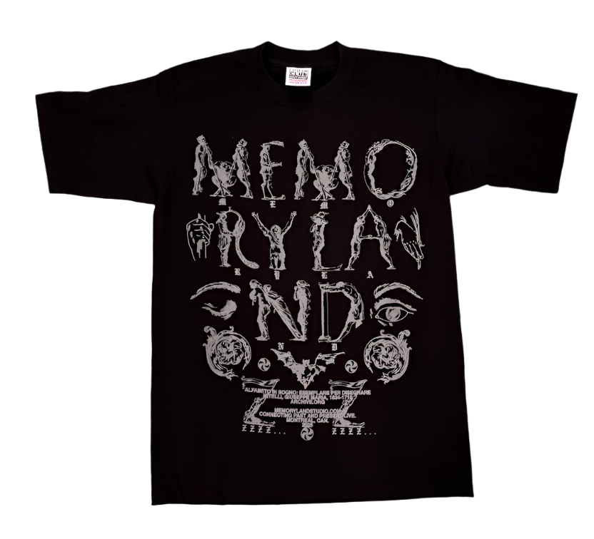 Black t-shirt with white text and graphics on a gray tiled floor