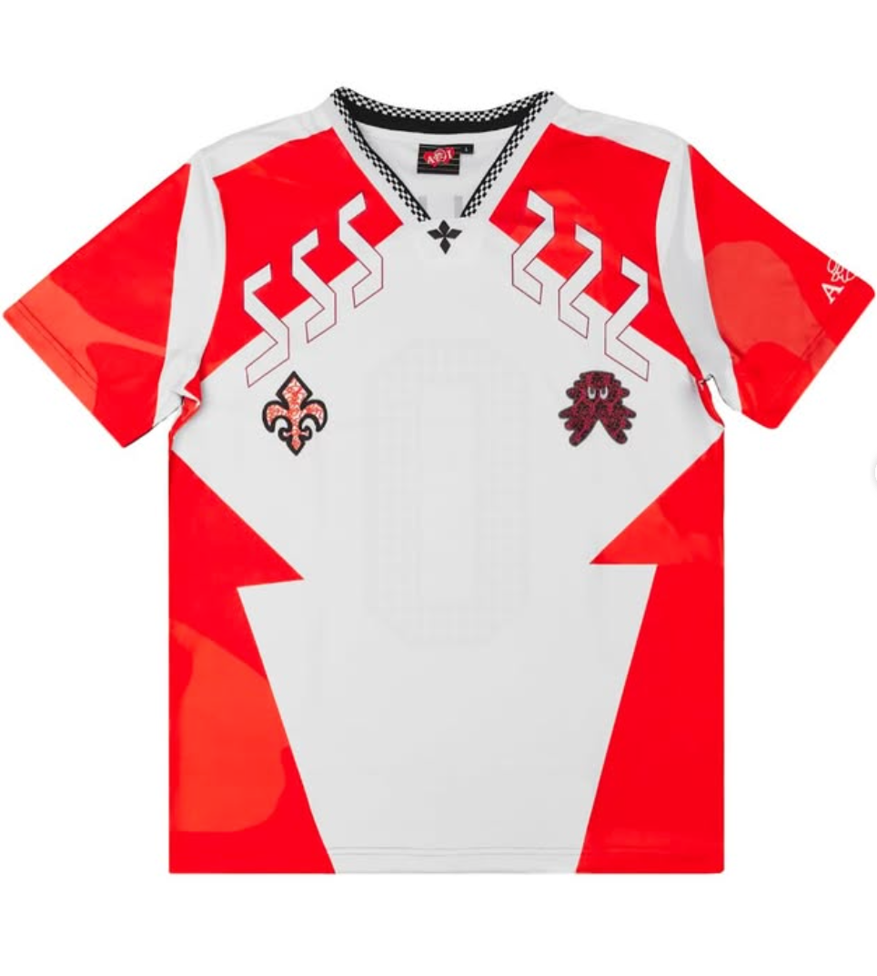 red and white soccer jersey with a fleur de lis and a octopus design. on a white background