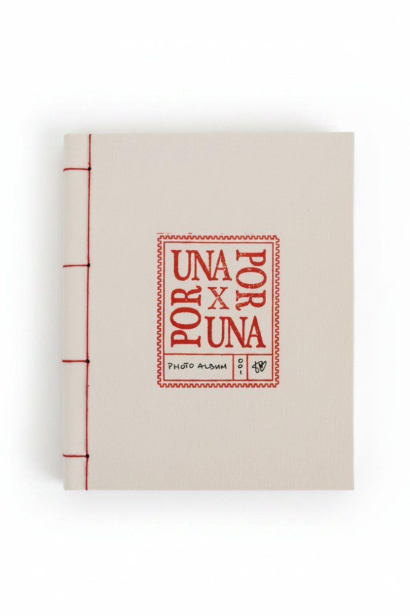 A square white album or book cover with red printed text reading 'POR UNA X UNA' and '1960 ALBUM', photographed against a dark green background.