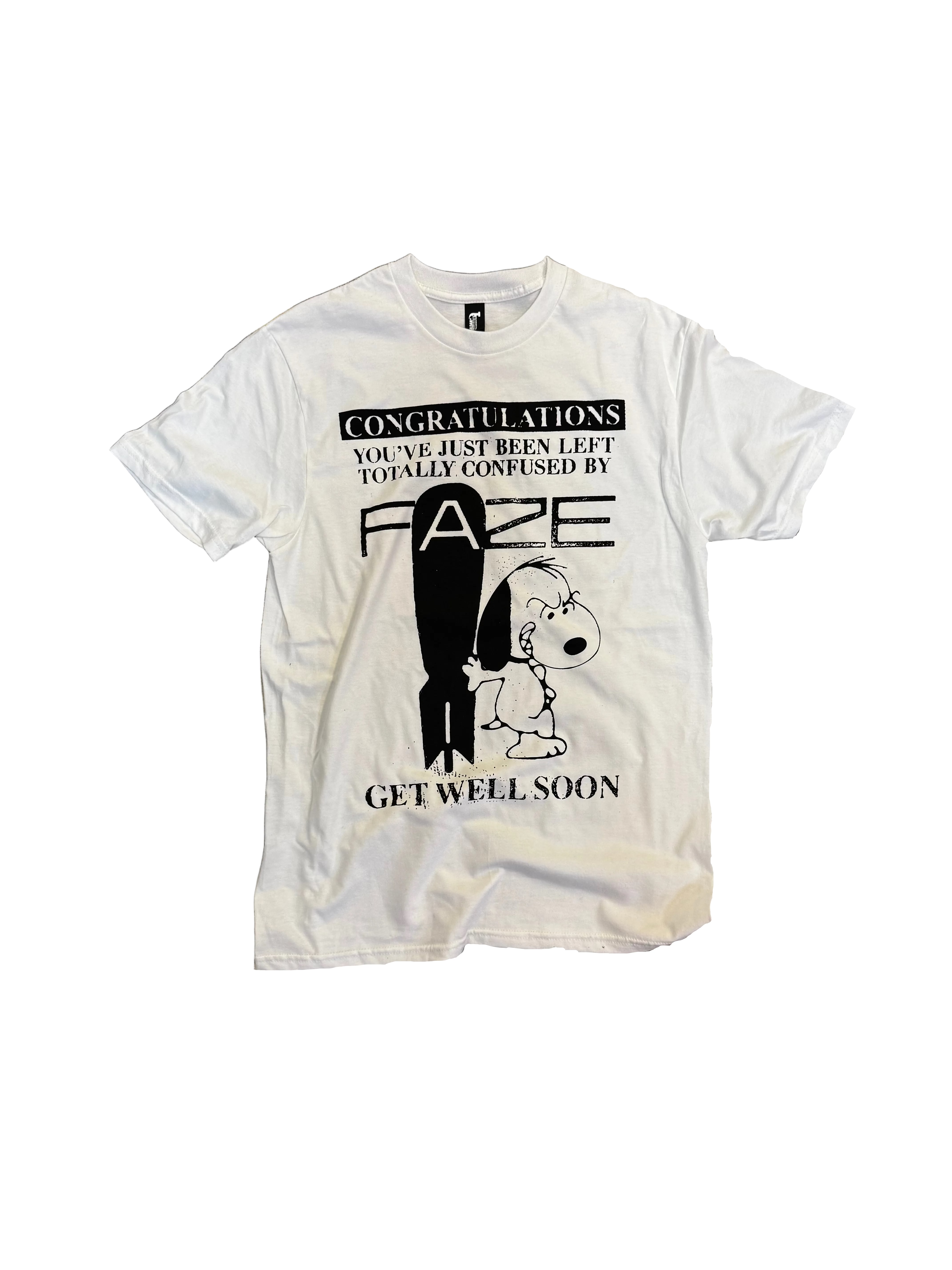 A white short-sleeve graphic t-shirt featuring a black print of Snoopy and a surfboard with the text 'CONGRATULATIONS YOU'VE JUST BEEN LEFT TOTALLY CONFUSED BY FAZE GET WELL SOON'.