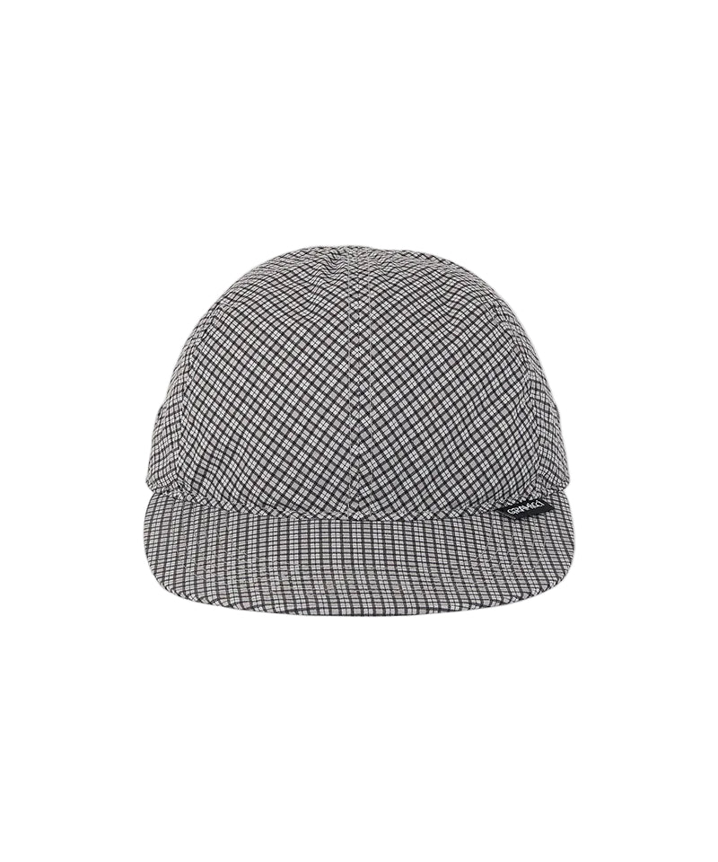 A structured cap with a fine black and white micro-check pattern, featuring a curved brim and a small black brand tag on the side, set against a plain white background.
