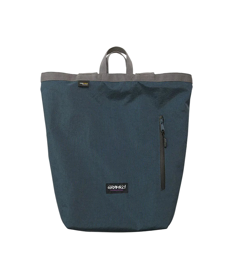 A dark teal blue-green waterproof tote bag with gray trim and handles, featuring a vertical zippered pocket on the front and a visible Growaki brand patch.