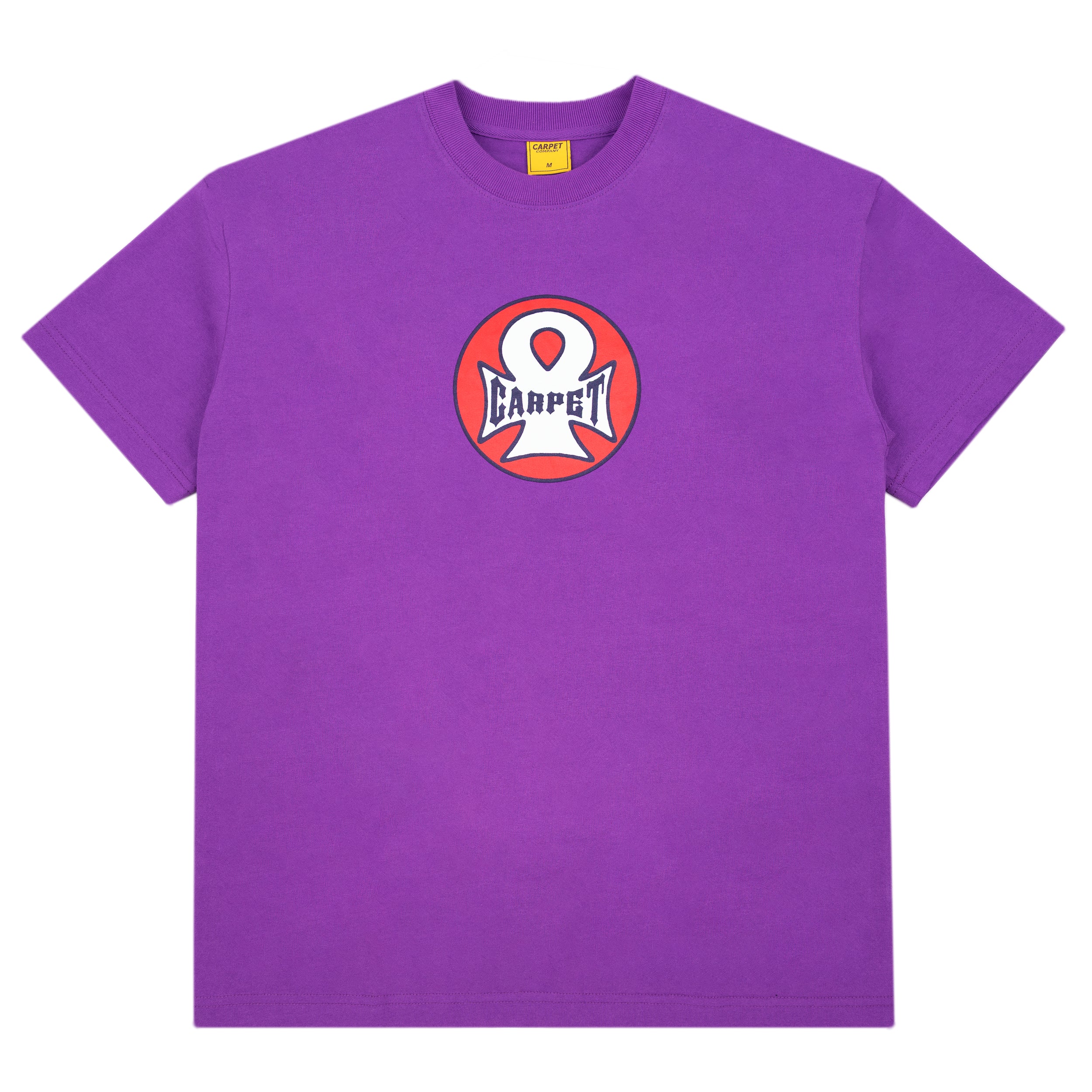 A purple short-sleeve crewneck t-shirt featuring a circular chest graphic with a white stylized character and the word 'CARPET' in navy on a red and orange background.