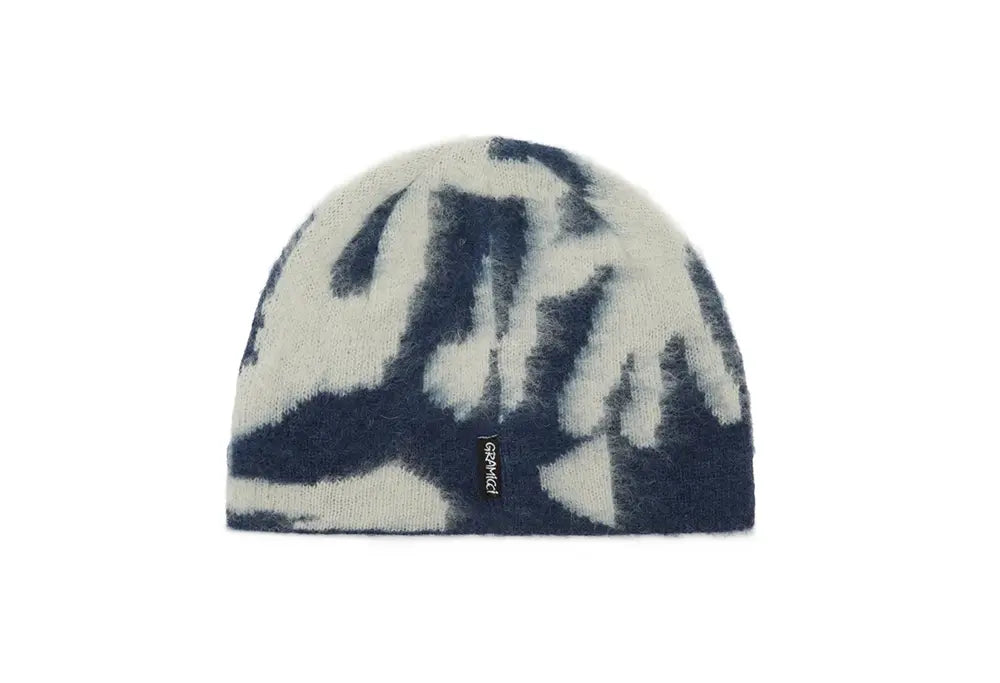 Navy and white tie-dye beanie with a brand logo on a white background