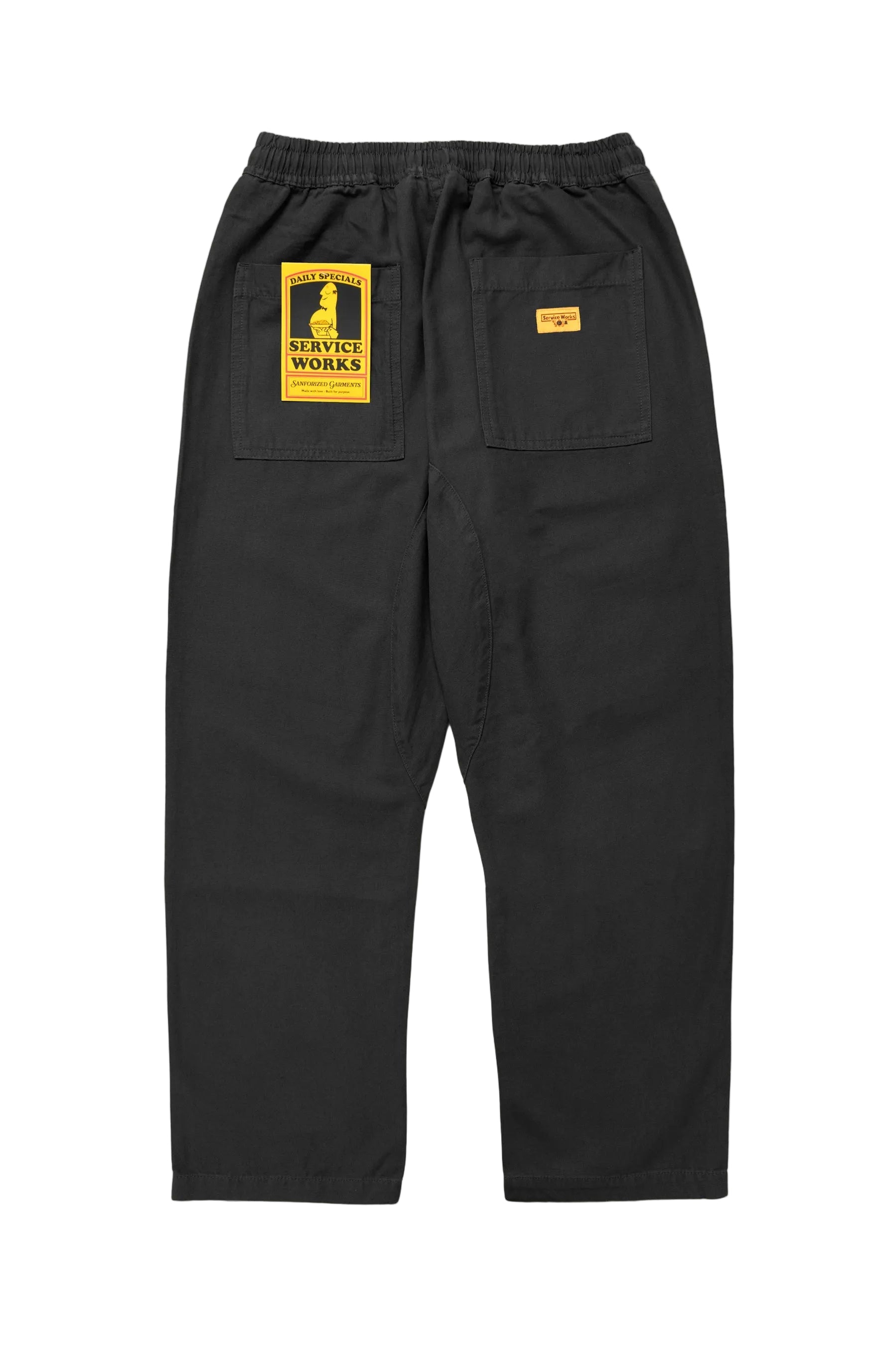 the chef pant from service work in black with a yellow woven label on the back right pocket. 