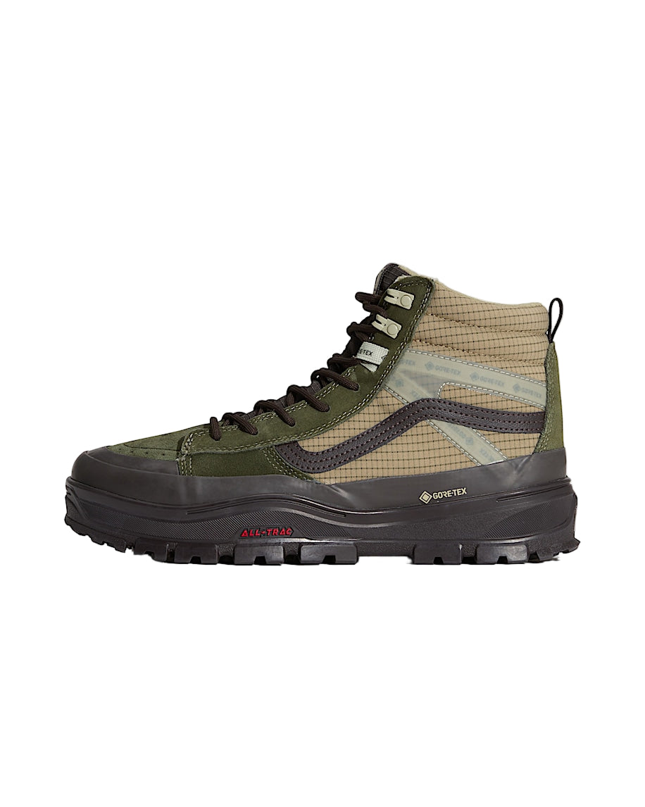 Green hiking boot with black sole on a light gray background
