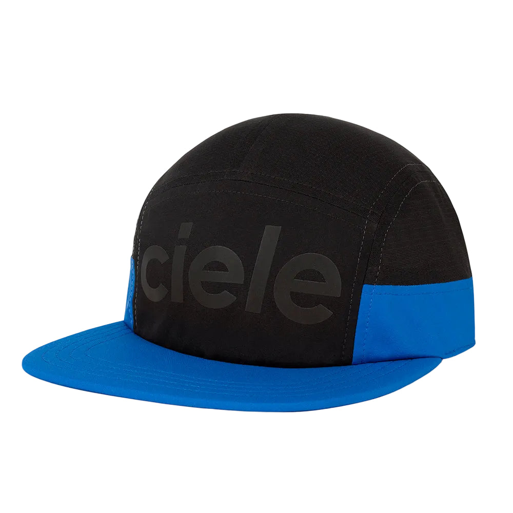 A black and blue 5-panel cap with a flat brim, featuring the brand name 'ciele' in a dark gray tone on the front panel and a bright blue brim.