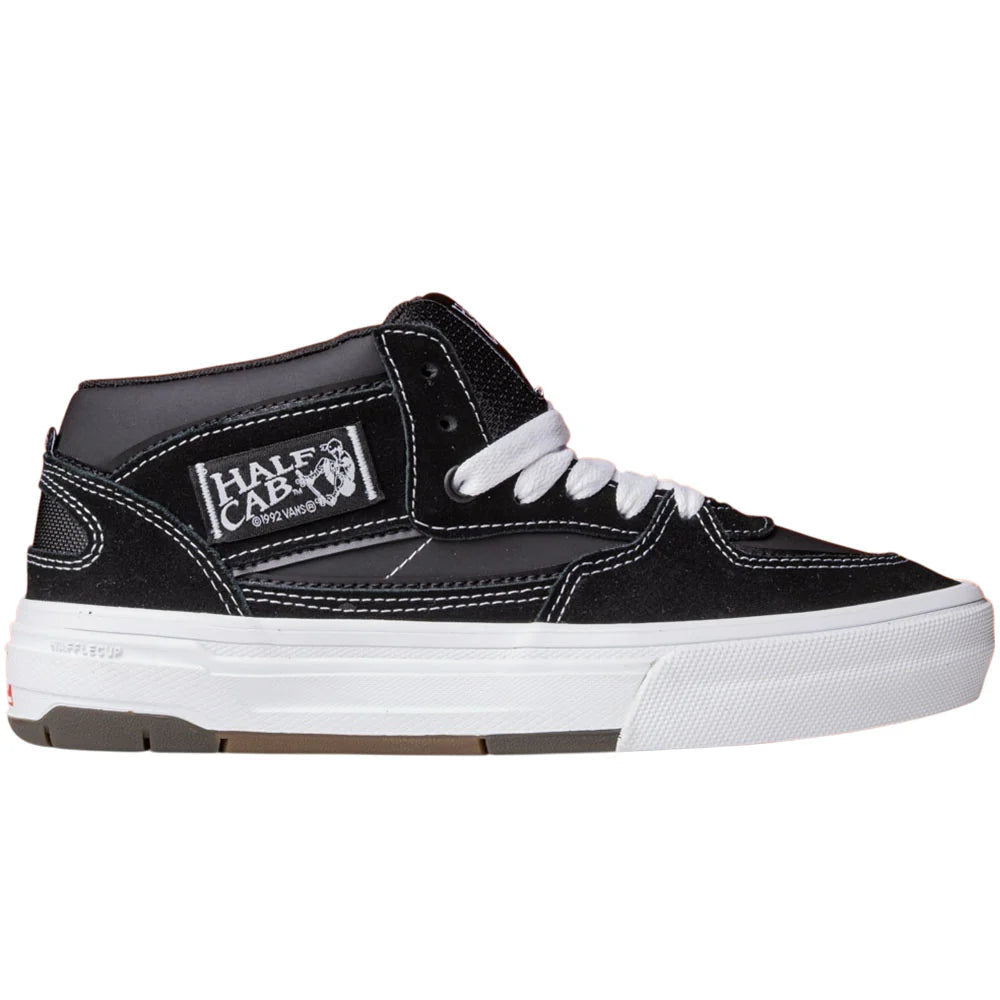 Black and white sneaker with a visible Half Cab brand logo on a white background