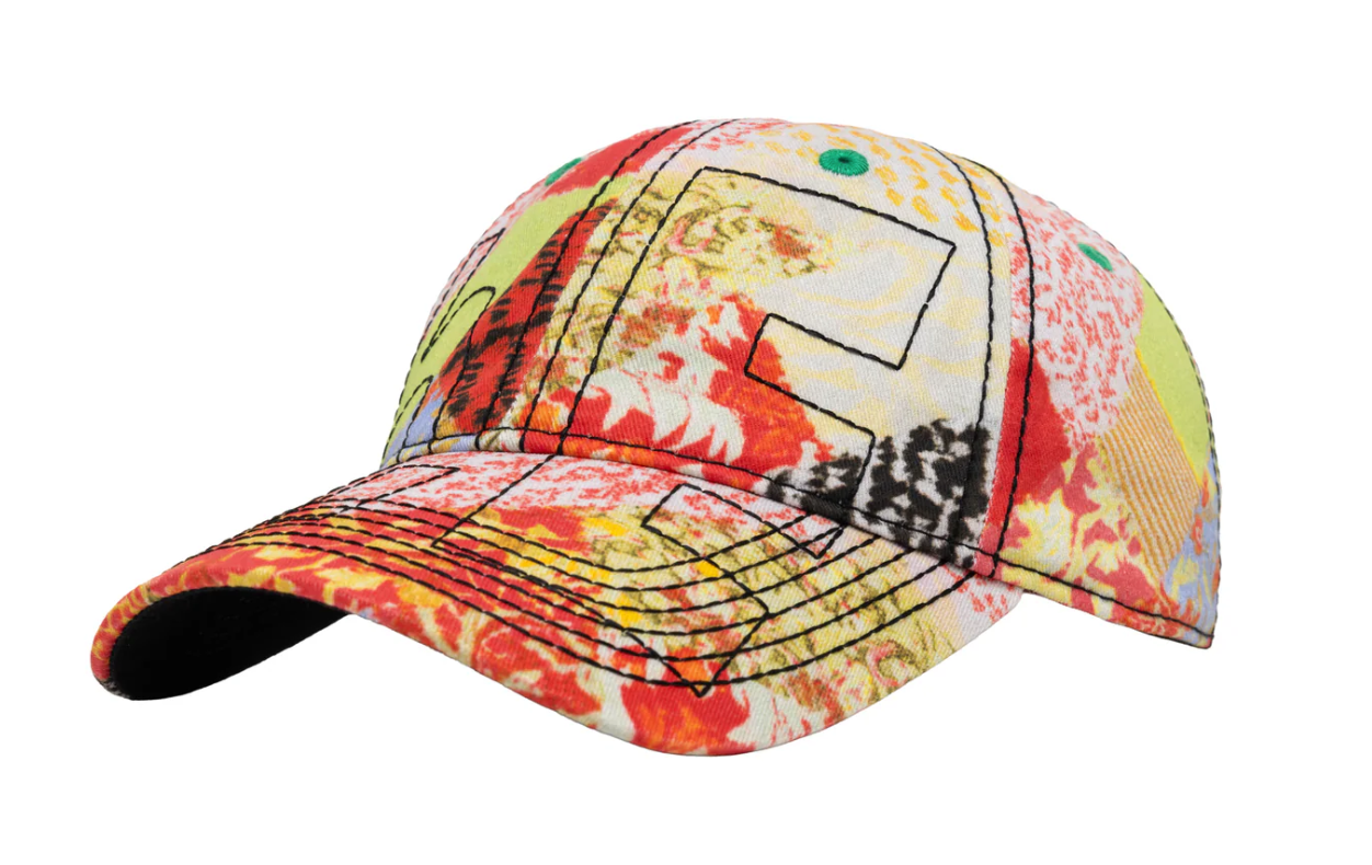 A baseball cap featuring a vibrant, multicolored abstract pattern with red, yellow, orange, green, and black stitched geometric details, shown against a plain white background.