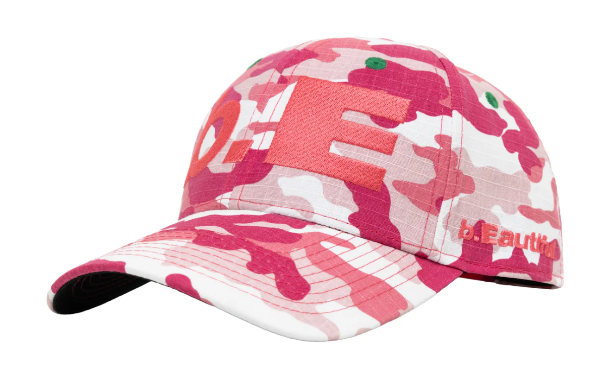 A baseball cap featuring a pink and white camouflage pattern with a large red 'LOVE' graphic on the front and 'beautifull' text on the side, shown against a plain white background.