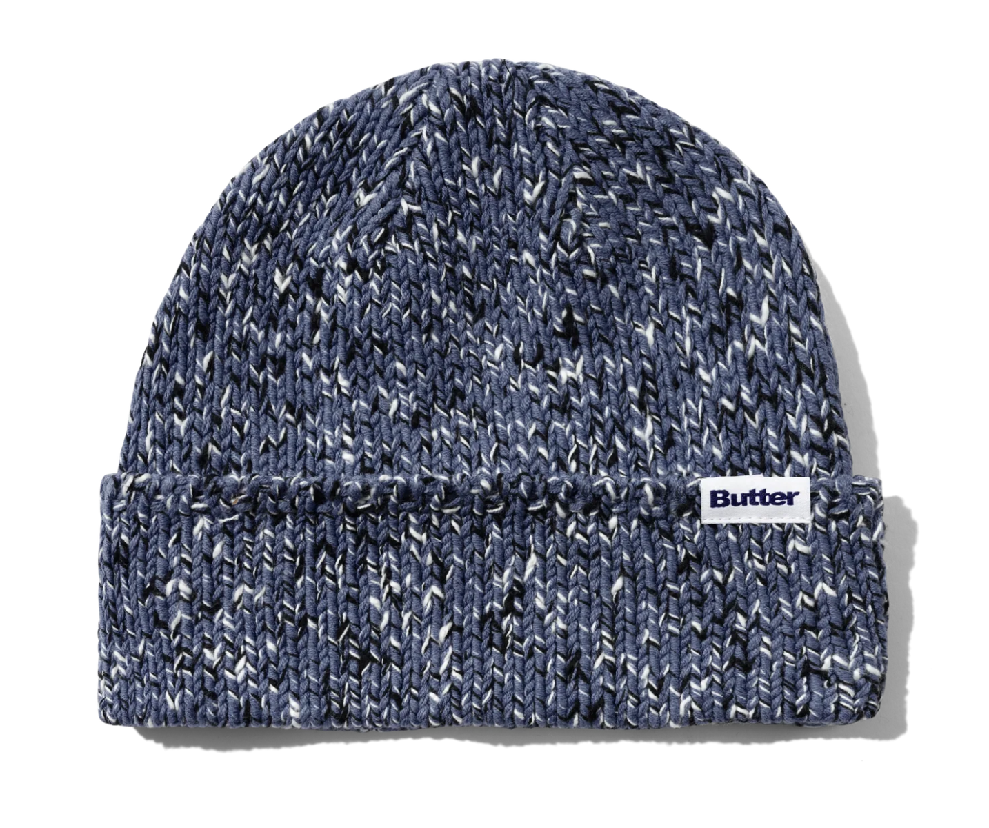 A navy blue marled knit beanie hat with a white fabric label on the cuff that reads 'Butter'.