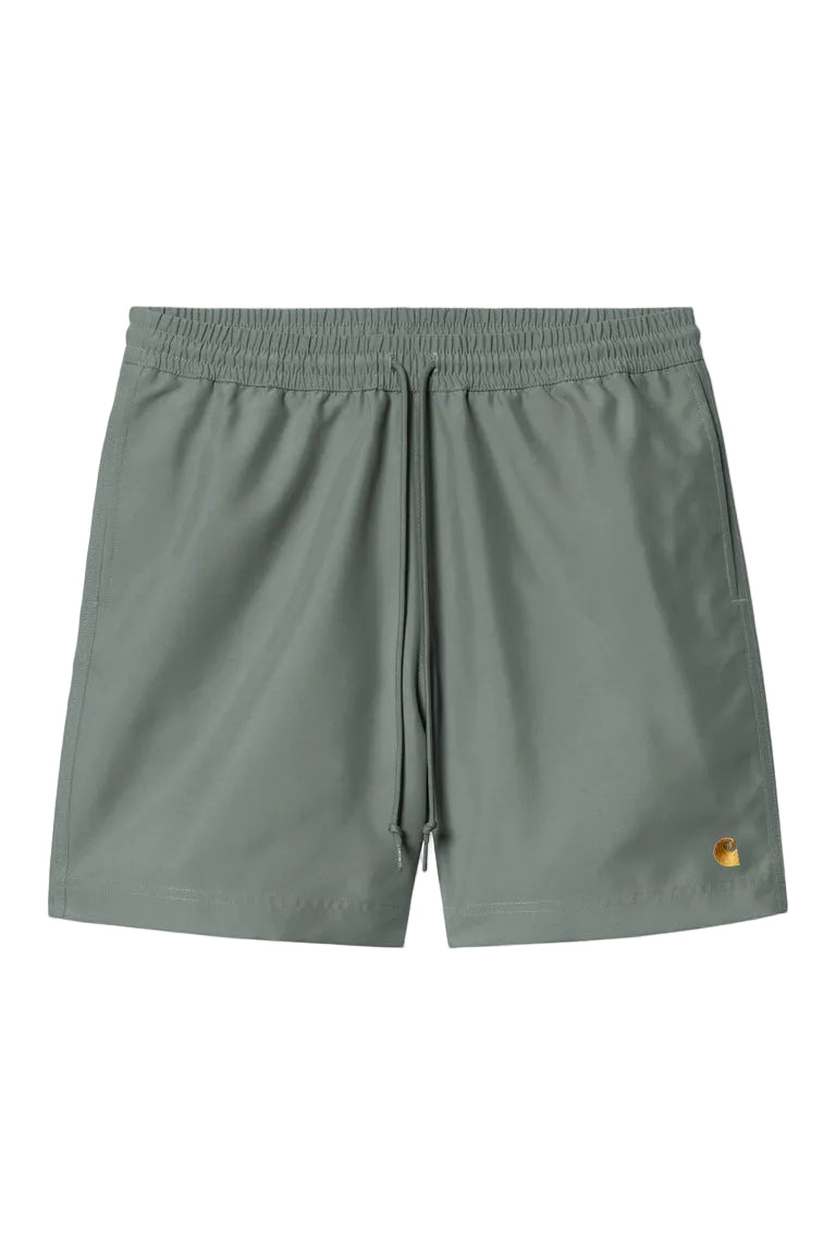 Green shorts with a brand logo on a white background