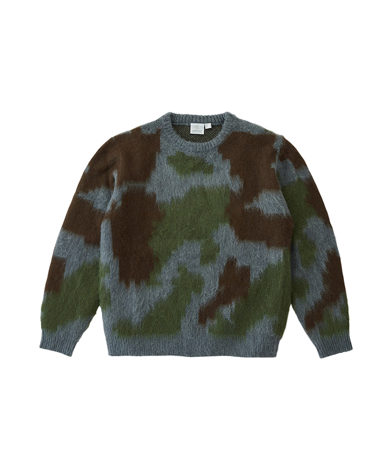 Camouflage-patterned sweater on a light gray background