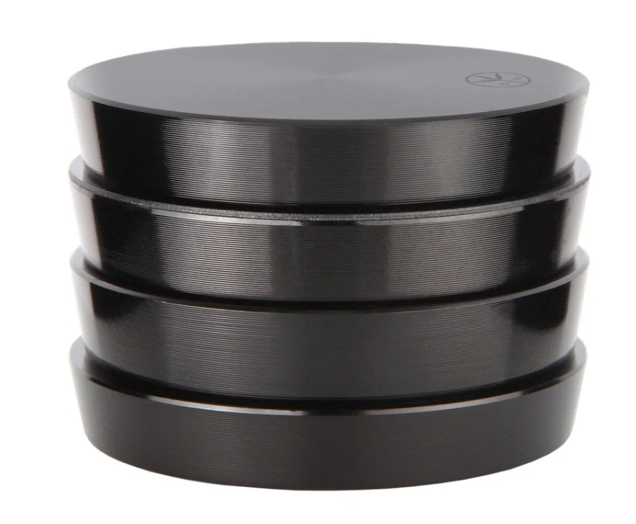 Stack of black metal discs on a white background